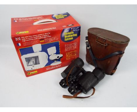 A boxed wireless camera monitoring system and a cased pair of binoculars.