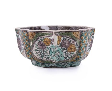 A Chinese Famille Verte lobed bowl, Kangxi, painted with aubergine, two tones of green, yellow and black with flower panels, 