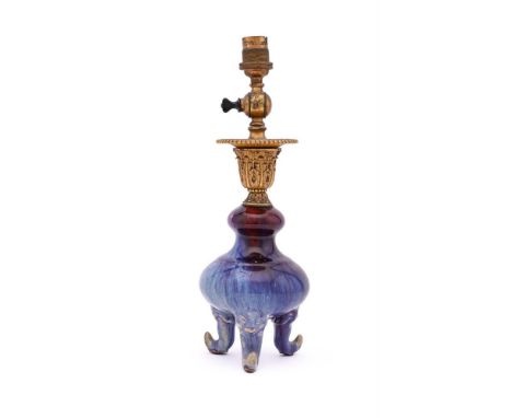A Chinese flambé tripod vase, Qing Dynasty, covered overall with a brilliant rich purple glaze with milky-blue and lavender s