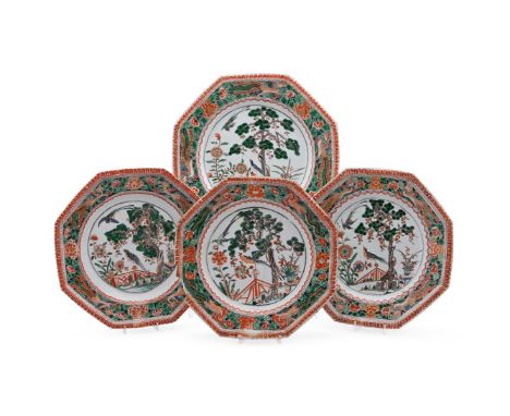 Four Chinese Famille Verte octagonal dishes, Kangxi, each with 'pie-crust' border, painted with two birds beside a pine tree 
