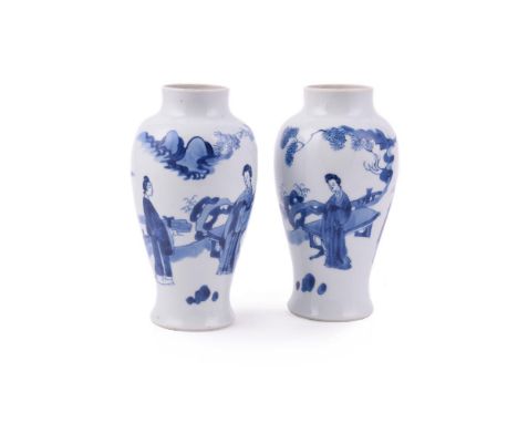 A pair of Chinese blue and white vases, Kangxi, one painted with three ladies in a garden and the other with two ladies and t