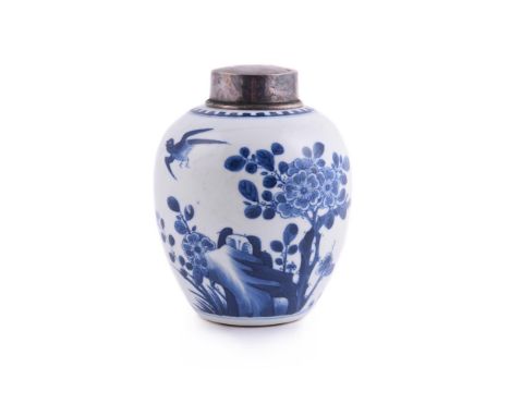 A small Chinese blue and white ginger jar, Kangxi, painted to the sides with flower branches and birds in flight, with silver