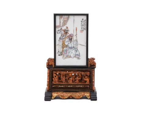 A Chinese famille rose porcelain table panel, 20th century, after Wang Qi, the panel inset on a lacquered stand carved in hig