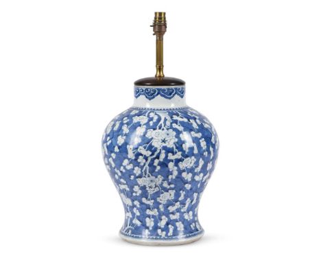 A Chinese blue and white baluster vase, Kangxi, decorated to the body with prunus against crackle ice ground, adapted as a la