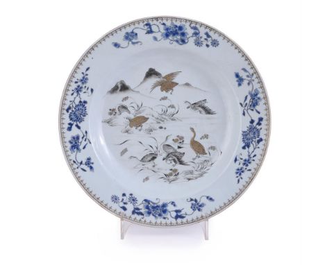 A large Chinese gilt and grisaille plate, kangxi, painted to the interior with geese in flight and on river banks, 35cm diame