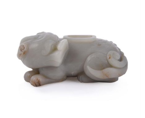 A Chinese pale celadon jade water pot, in Ming style, the recumbent mythical animal bixie is carved in relief with its head t