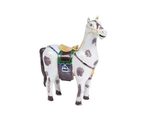 A Chinese porcelain model of a piebald horse, late Qing Dynasty, in 18th century style, the white ground glazed in aubergine 