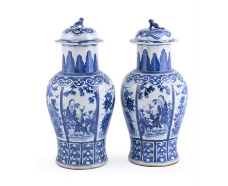 A pair of Chinese blue and white vases and covers, Qing Dynasty, 19th century, painted with alternating panels of lady and an