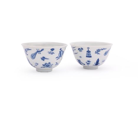 A pair of Chinese blue and white 'Daoist Emblems' tea bowls, Kangxi, the bases with six-character Chenghua mark in underglaze