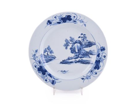 A Chinese blue and white charger, late Kangxi, painted with stylised layered rocks and trees, the border with lotus flower sp