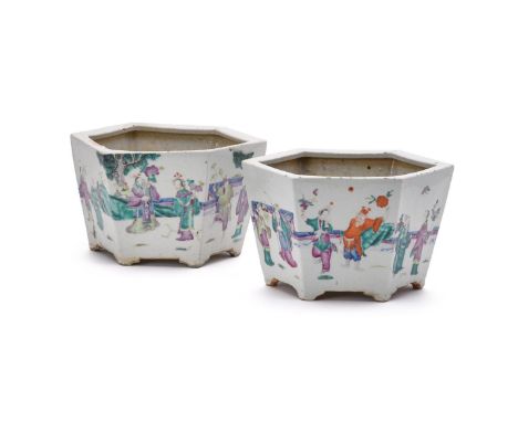A pair of Chinese Famille Rose hexagonal jardinières, late 19th century, each panel painted with pairs of figures on terraces