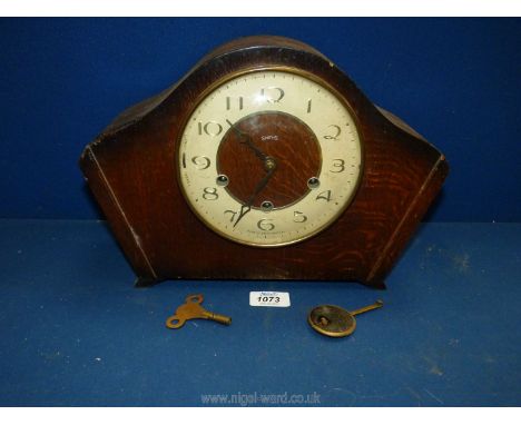 A Smiths mantle clock with key and pendulum.