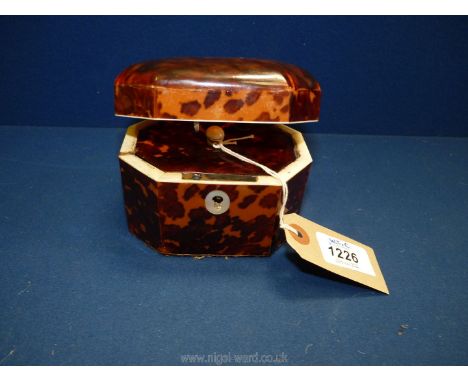 An octagonal turtle shell tea caddy, the lid opens to reveal a lidded compartment, with key, approx. 4 1/4" x 3" x 3 1/2".