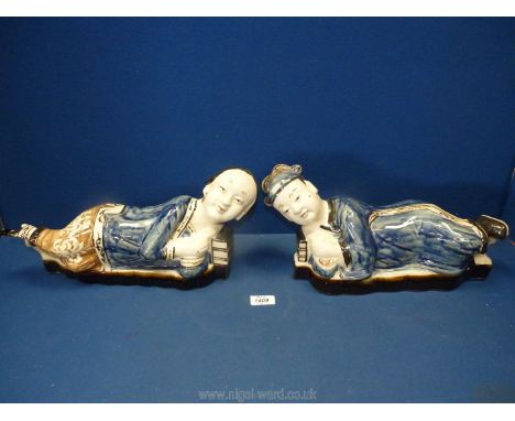 Two Chinese ceramic headrests, man and woman, 16'' long x 8'' high, hairline cracks.