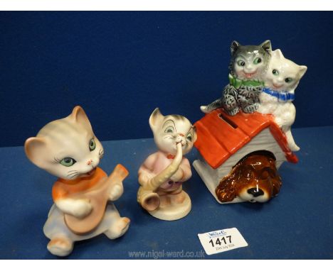 A Goebel Money box in the shape of a sleeping dog in his kennel with two cats on the roof together with two West German cats 