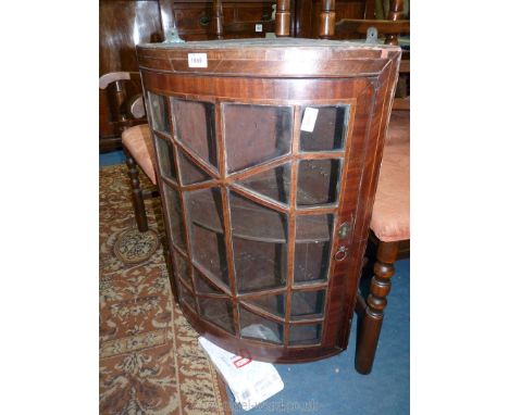 A most unusual bow fronted Mahogany framed geometrically glazed wall hanging Corner Cabinet with cross-banded light and darkw