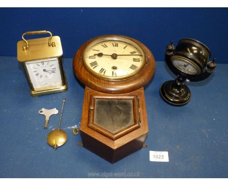 A black Bakelite clock, a wall clock and a carriage clock.