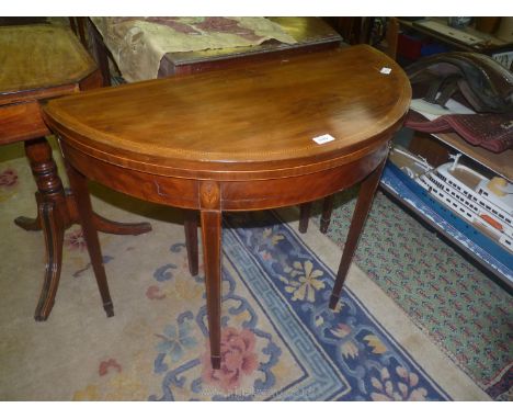 A fine quality Mahogany demi-lune flap-over Tea Table, the top intricately detailed with light and darkwood Herringbone strin