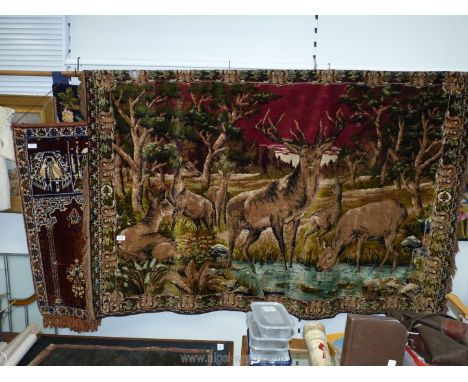 A large velvet wall tapestry of deer and stag by water, 6' x 47", plus a smaller wall tapestry.