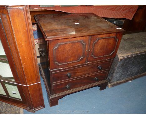 A circa 1800 Mahogany Commode having two false drawers to the front, the lid and upper front simulated double doors section l