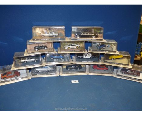 A box containing a quantity of 1:43 scale car models from 'The James Bond Car Collection', featured in the films 'A View to a