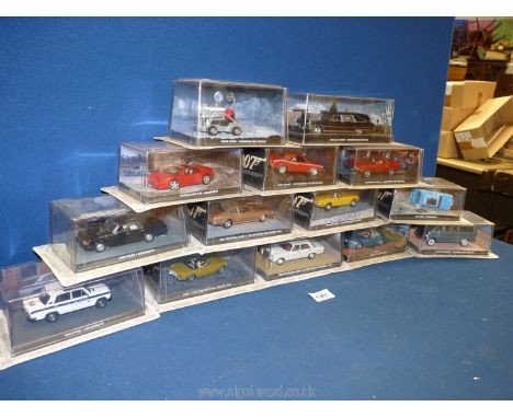 A box containing a quantity of 1:43 scale car models from 'The James Bond Car Collection', featured in the films 'The Man wit