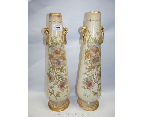 A pair of tall ceramic vases, cream and gold with floral relief, circa 1890, 17" tall.