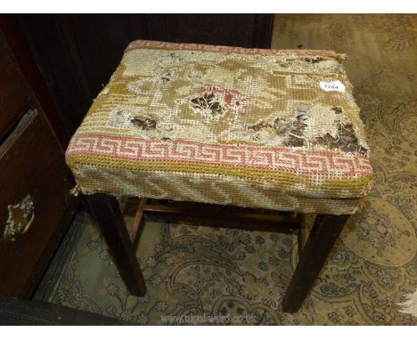 A well worn tapestry seated darkwood framed Stool having an ''H'' stretcher, 16'' x 13'' x 18 3/4'' high approx.