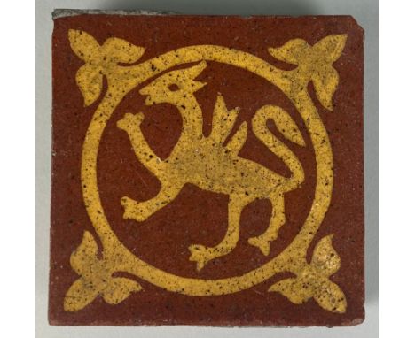 A VICTORIAN TILE CIRCA 1870 RED EARTHENWARE MOULDED AND INLAID WITH BUFF SLIP, By Godwin, Lugwardine, Hereford. 