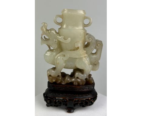 AN 18TH CENTURY CHINESE JADE WINGED DRAGON CARRYING AN ARCHAIC VASE, 7.5cm x 6.3cm x 2cmProvenance: Purchased by the vendor a