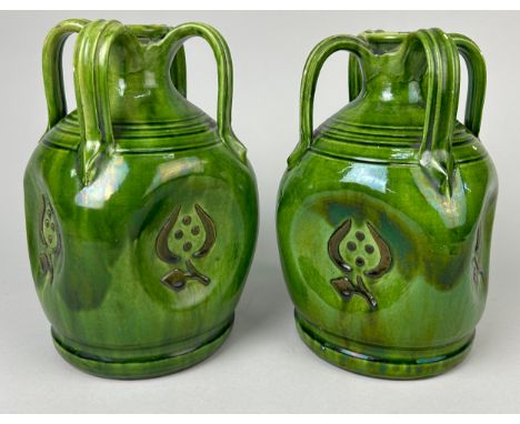 A PAIR OF ART NOUVEAU FOUR HANDLED GREEN GLAZED LUSTRE CERAMIC JUGS, 24cm x 15cm 