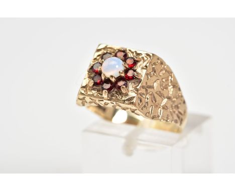 A 9CT GOLD CLUSTER RING, designed with a square engraved panel and shoulders upon which a central cluster consisting of a sin