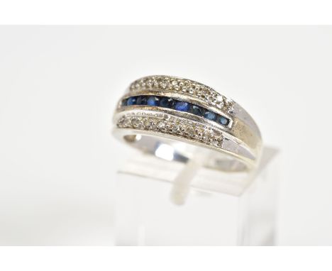 A 9CT WHITE GOLD SAPPHIRE AND DIAMOND RING, designed with a central row of circular cut sapphires, flanked by rows of single 