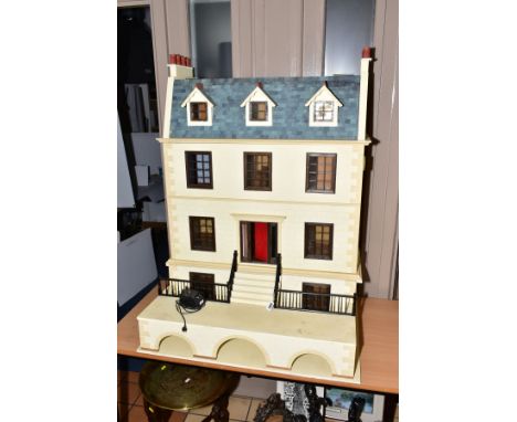 AN IMPRESSIVE WOODEN DOLLS HOUSE, modelled as a three storey town house with a basement, top three floors can be separated fr