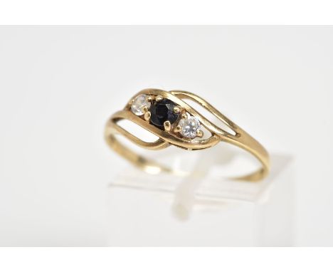 AN EARLY 20TH CENTURY 9CT GOLD RING, of open work design set with a diagonal row of a central circular cut sapphire flanked b