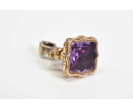 A 9CT GOLD FOB SEAL, with a scrolling design handle set with an amethyst, height 25mm, approximate weight 5.4 grams