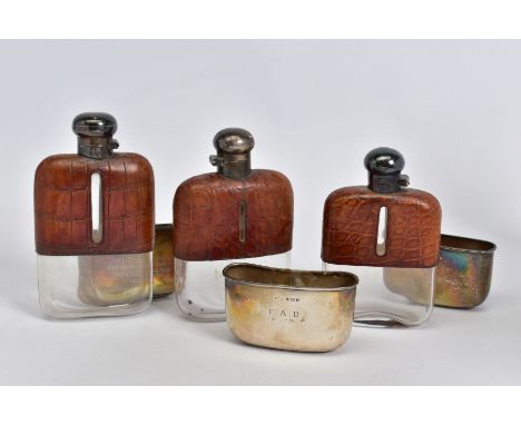 A SET OF THREE GRADUATED SILVER AND CROCODILE SKIN GLASS HIP FLASKS with quarter turn caps&nbsp; Condition Report&nbsp; Tarni