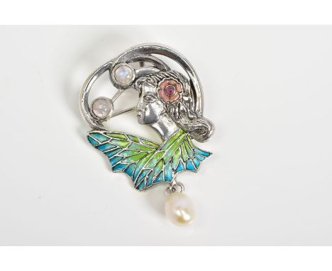 A PLIQUE-A-JOUR BROOCH, in the form of a maiden with a red enamel flower in her hair, set with two moonstones with blue and g