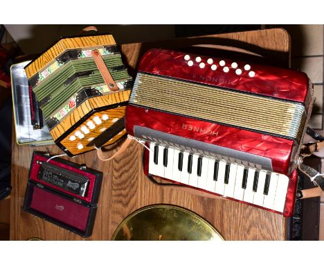 A HOHNER MIGNON 2 ACCORDIAN in pearl red, a German Modern concertina, a Huang Chromatic Harmonica and another Harmonica (4)