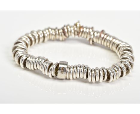 A LINKS OF LONDON BRACELET, the stretch charm bracelet made up circular links, with a plain polsihed ring stamped 925, approx
