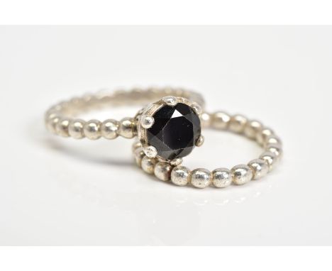 TWO PANDORA RINGS, the first set with a circular cut onyx within a six claw setting, with scrolling detail mount, to the bead