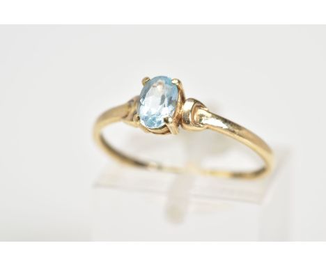 A SINGLE STONE RING, set with a central oval cut aquamarine within a four claw setting, to the plain polished band, stamped 9