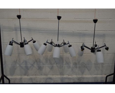 A SET OF THREE 1970'S MODERNIST ITALIAN STYLE FIVE BRANCH CEILING LIGHTS, with a chrome frame and shaped glass shades, diamet