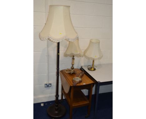 A 1970'S TEAK OVAL DROP LEAF TEA TROLLEY, an oak standard lamp, two tables lamps, all with fabric shades and a barometer (5)
