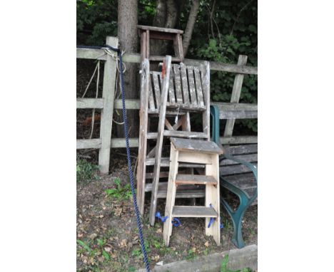 FOUR VINTAGE WOODEN STEP LADDERS, of varying ages, 77cm, 2 x 107cm and 144cm high, folded