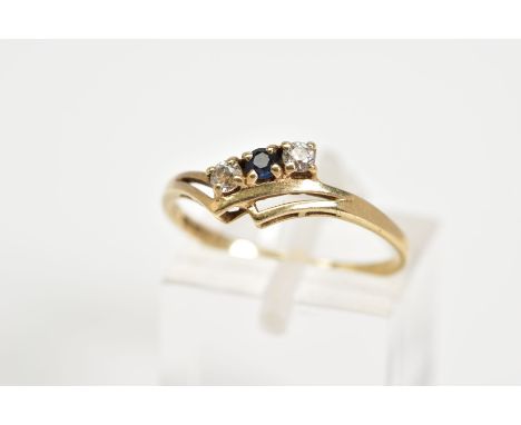 A 9CT GOLD RING, designed with a double V shape shank with a row of two round brilliant cut cubic zirconia interspaced with a