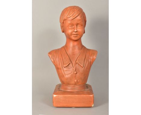 A TERRACOTTA GLAZED CERAMIC BUST OF A YOUNG BOY, on a square plinth base, chipped front corner, height 42cm