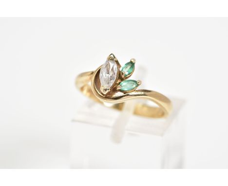 A 9CT GOLD THREE STONE RING, designed with a marquise cut cubic zirconia with two marquise cut emeralds on one side with a pl