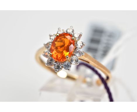 A 9CT GOLD OPAL CLUSTER RING, set with a central oval cut fire opal with a circular cut zircon surround, to the plain polishe