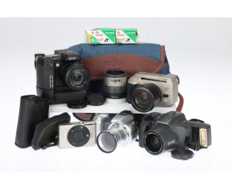 A Small Collection of Bridge and Compact Cameras comprising a Minolta Vectis S-1 APS SLR camera with 22-80mm and 50mm lenses,